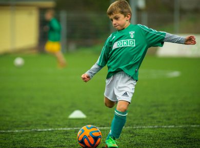 little boy playing football